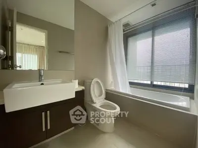Modern bathroom with sleek fixtures and large window for natural light.