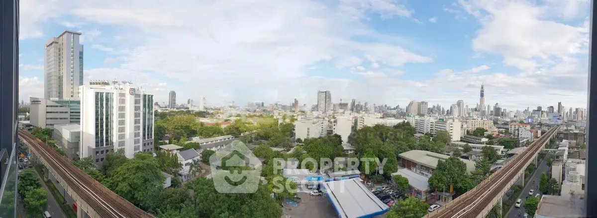 Stunning panoramic cityscape view from high-rise building with lush greenery and urban skyline.