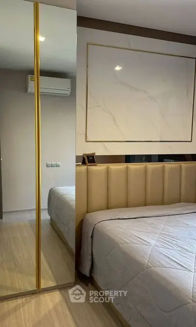 Modern bedroom with elegant decor and mirrored wardrobe