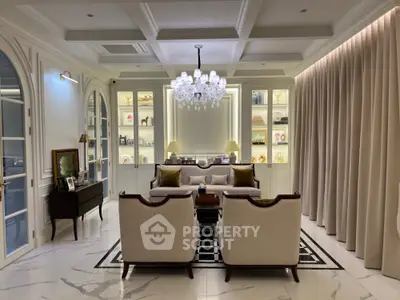 Luxurious living room with elegant chandelier and plush seating in a sophisticated setting.