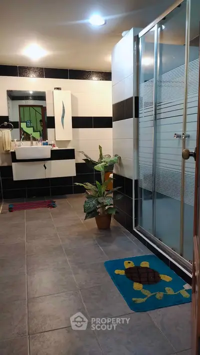 Spacious modern bathroom with shower and stylish decor