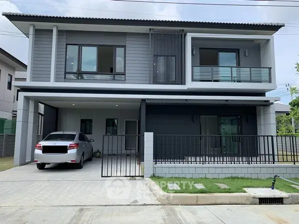 Modern two-story house with carport and sleek exterior design