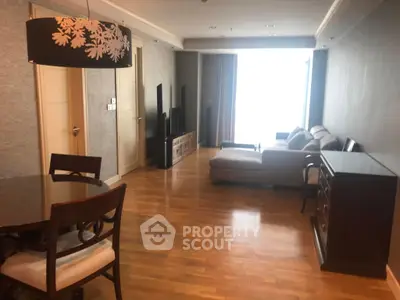 Spacious living room with elegant decor and hardwood flooring in modern apartment.