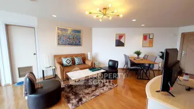 Spacious modern living room with stylish decor and dining area, featuring elegant lighting and wooden flooring.