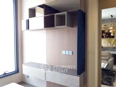 Modern interior with sleek storage and elegant lighting in a stylish apartment.