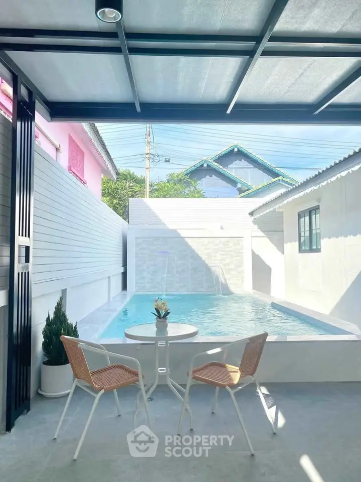 Charming poolside patio with modern seating and serene ambiance