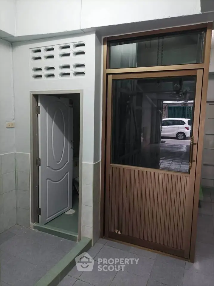 Cozy entrance with modern door design and tiled flooring in a residential property.