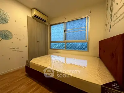 Cozy bedroom with air conditioning and stylish decor, perfect for relaxation.