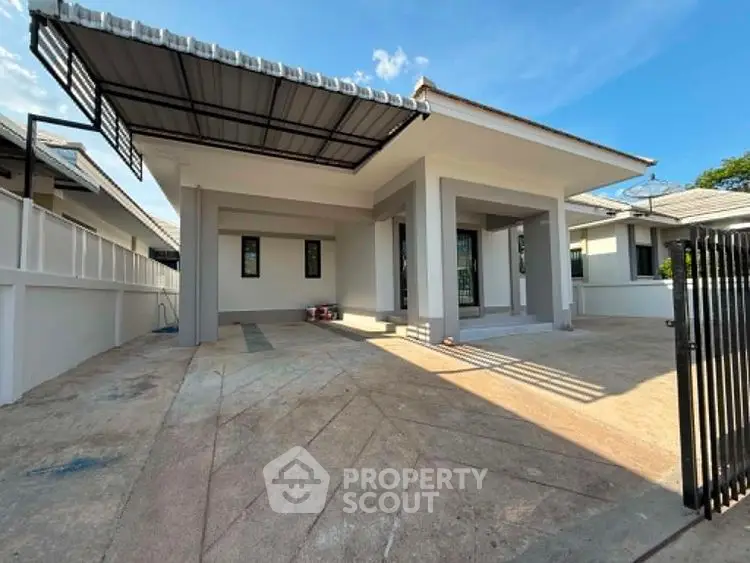 Modern single-story house with spacious driveway and covered carport in a serene neighborhood.