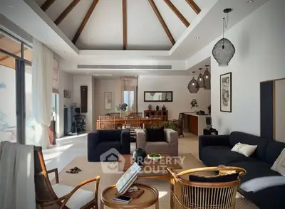 Luxurious open-plan living room with elegant decor and high ceilings, perfect for modern living.