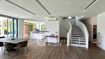 Spacious modern living room with open kitchen and elegant staircase in luxury home
