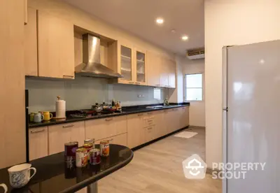 Spacious modern kitchen with sleek cabinetry and stainless steel appliances