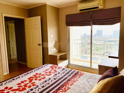 Bright bedroom with balcony and city view in modern apartment