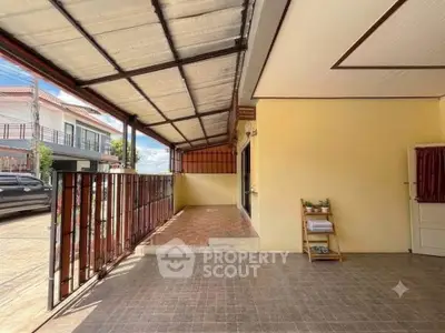 Spacious covered patio with tiled flooring and street view
