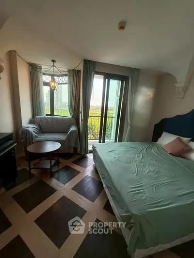 Charming bedroom with balcony and stylish decor, featuring parquet flooring and cozy seating area.