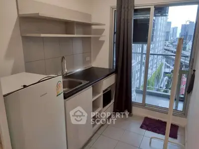 Modern kitchen with balcony view in urban apartment