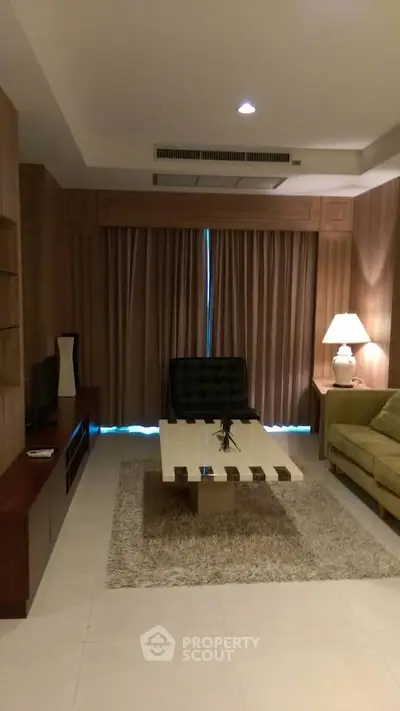Elegant living room with modern furniture and cozy lighting, perfect for relaxation and entertainment.