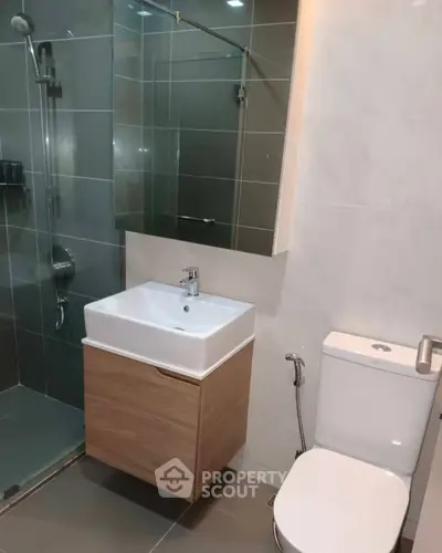 Modern bathroom with sleek fixtures and glass shower enclosure