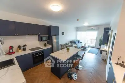 Modern open-plan kitchen and living room with sleek design and natural light