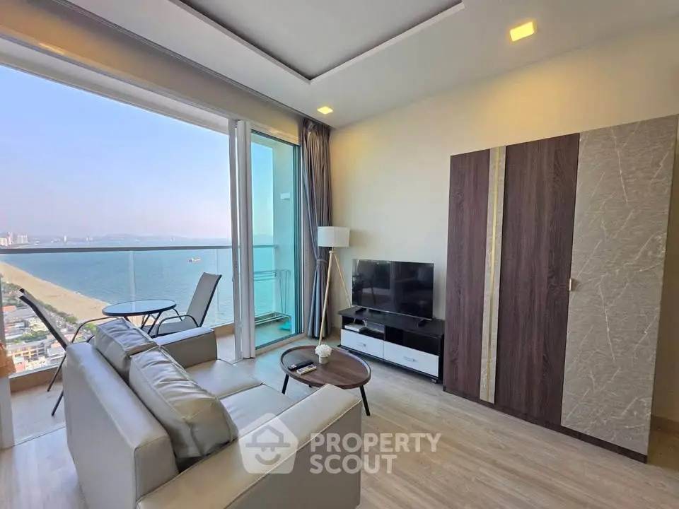 Stunning beachfront living room with modern decor and expansive ocean views.
