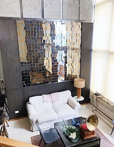 Stylish living room with modern decor and large mirrored wall feature