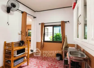 Charming kitchen with open layout and vibrant tile flooring, featuring a compact sink and ample natural light.