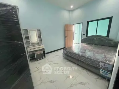 Spacious bedroom with modern furniture and elegant flooring