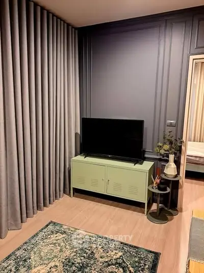 Modern living room with stylish decor and TV unit, featuring elegant curtains and a cozy ambiance.