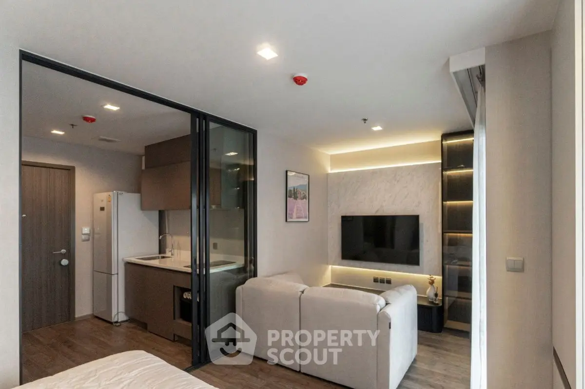 Modern open-plan living room with sleek kitchen and cozy seating area