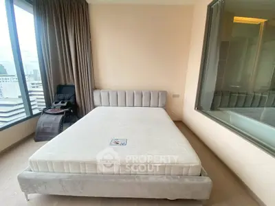 Modern bedroom with city view and luxurious bed in high-rise apartment