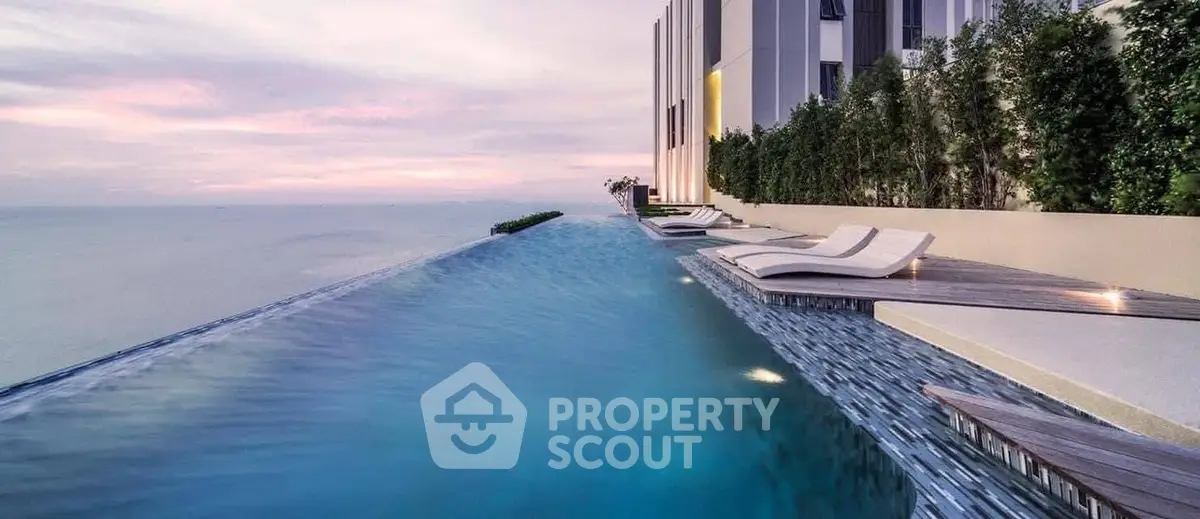 Luxurious rooftop infinity pool with stunning ocean view at sunset.