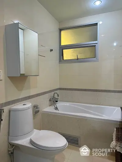 Modern bathroom with bathtub and sleek fixtures in a stylish apartment.