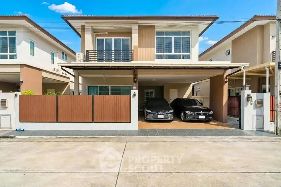 Modern two-story house with spacious driveway and two cars parked, showcasing contemporary architecture and design.