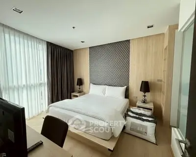 Modern bedroom with stylish decor and large windows in a luxury apartment.