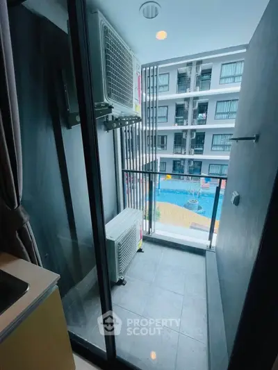 Modern balcony with pool view in a stylish apartment complex