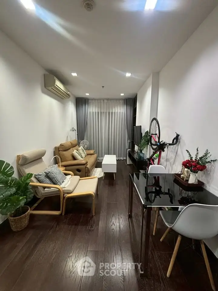 Modern living room with cozy seating and stylish decor in a contemporary apartment.