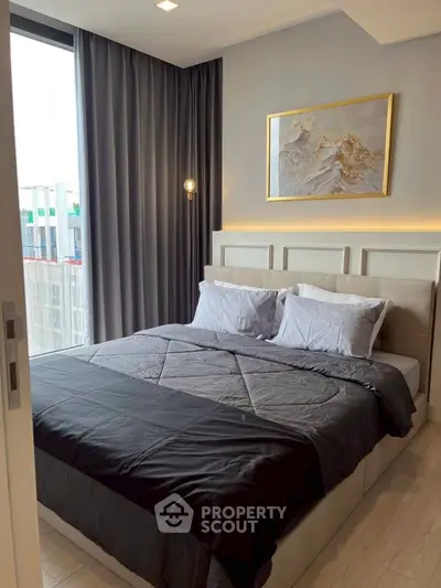 Modern bedroom with elegant decor and large window view