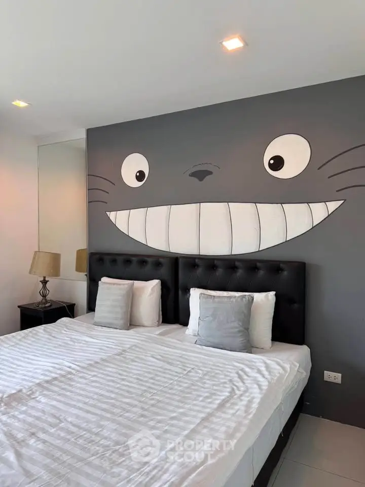 Charming bedroom with playful wall art and cozy twin beds, perfect for a unique living experience.