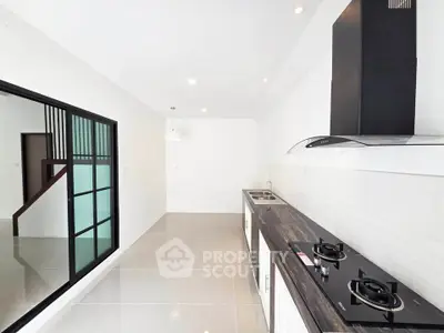Modern kitchen with sleek design, featuring gas stove and ample counter space, perfect for culinary enthusiasts.
