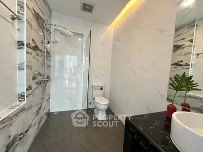 Luxurious modern bathroom with marble walls and sleek fixtures
