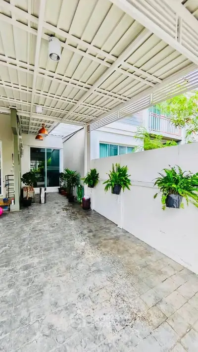 Spacious covered outdoor area with modern design and lush greenery