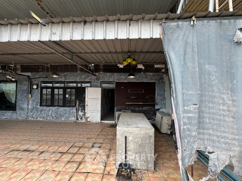 Spacious outdoor terrace with rustic charm and potential for renovation.