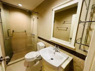 Modern bathroom with glass shower and elegant fixtures