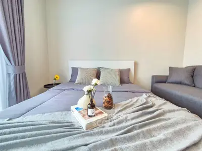 Cozy bedroom with elegant decor and soft lighting, featuring a comfortable bed and stylish furnishings.