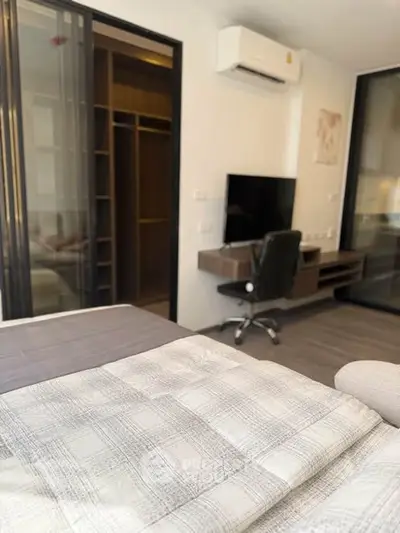 Modern bedroom with workspace and closet in stylish apartment