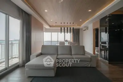 Spacious modern living room with large windows and elegant decor