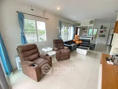 Spacious living room with plush seating and large windows for natural light.