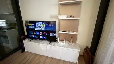 Modern living room with sleek TV setup and stylish shelving