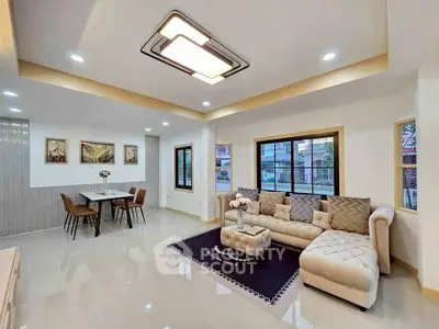 Spacious modern living room with elegant decor and large windows for natural light.