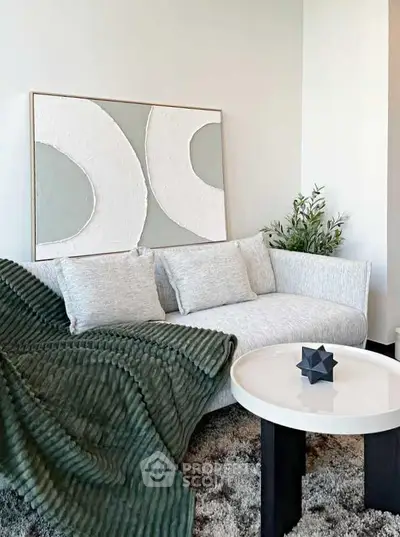 Modern living room with stylish sofa, abstract art, and cozy decor